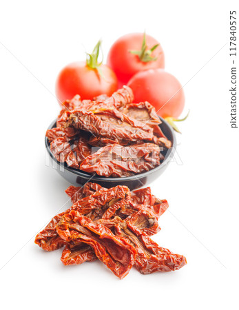 Sun dried red tomatoes isolated on white background. 117840575