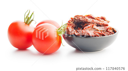 Sun dried red tomatoes in bowl isolated on white background. 117840576