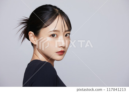 Chic makeup image of a young woman wearing a black knit 117841213
