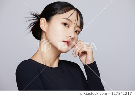 Chic makeup image of a young woman wearing a black knit Chic makeup image of a young woman wearing a black knit 117841217