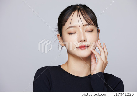 Chic makeup image of a young woman wearing a black knit 117841220
