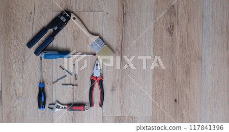 A set of tools for home repair lies on the floor, close-up 117841396