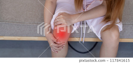 Young Woman Holding Painful Knee. Knee Pain and Discomfort Young Woman Holding Painful Knee. Knee Pain and Discomfort 117841615