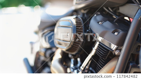 Part of a motorcycle in detail, close-up, blurry 117842482