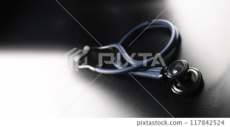 Black stethoscope on a dark matte background Black stethoscope on a dark matte background 117842524