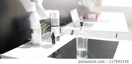 White robotic arm manipulator on gray background White robotic arm manipulator on gray background 117842556
