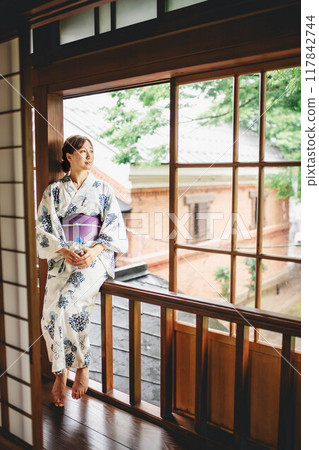 A woman in a yukata with a ramune 117842744