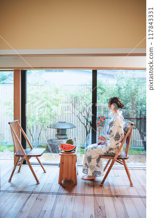 A woman in a yukata eating watermelon A woman in a yukata eating watermelon 117843331