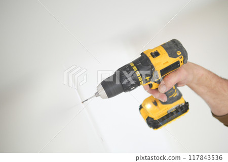 using electric drilling on white wooden board using electric drilling on white wooden board 117843536