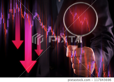 Investor analyzing charts of stock market price movements during economic downturn. Investment strategies during stock market decline. Man holding magnifying glass. 117843696