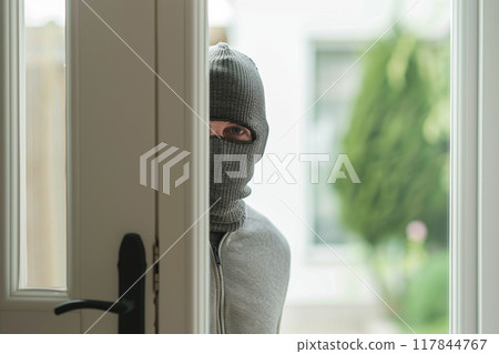 Masked Person Peeking Through Doorway Masked Person Peeking Through Doorway 117844767