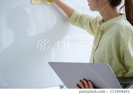 A young woman visualizing issues in the office A young woman visualizing issues in the office 117844841