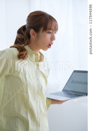 A young woman visualizing issues in the office A young woman visualizing issues in the office 117844896