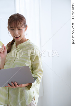 A young woman visualizing issues in the office 117844898