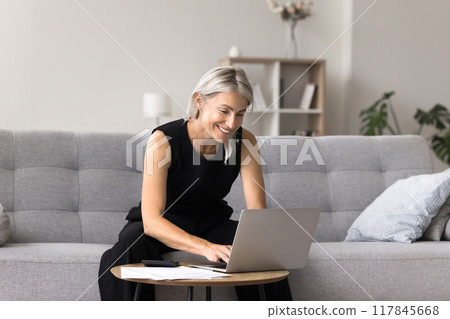 Woman check bills, do paperwork, feel satisfied with financial stability 117845668