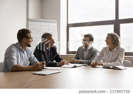 Board of directors negotiating seated at conference table Board of directors negotiating seated at conference table 117845730