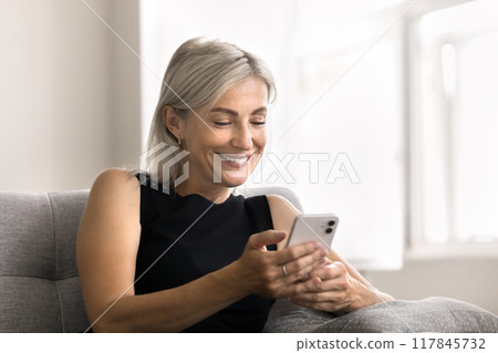 Woman enjoy chat with friend using smartphone Woman enjoy chat with friend using smartphone 117845732