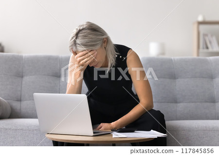 Mature woman depressed about financial concerns and debts Mature woman depressed about financial concerns and debts 117845856