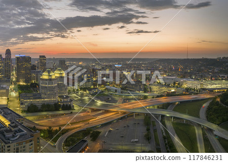 USA transportation infrastructure concept. View from above of American big freeway intersection in Cincinnati city, Ohio at night with fast moving cars and trucks USA transportation infrastructure concept. View from above of American big freeway intersection in Cincinnati city, Ohio at night with fast moving cars and trucks 117846231