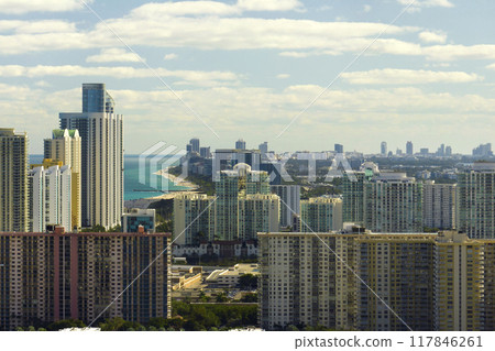 View from above of luxurious highrise hotels and condos on Atlantic ocean shore in Sunny Isles Beach city. American tourism infrastructure in southern Florida 117846261