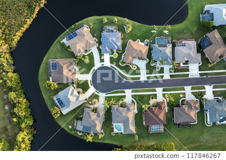 View from above of residential houses in living area in North Port, FL at evening. Illuminated American dream homes as example of real estate development in US suburbs 117846267