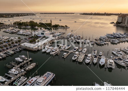 Sarasota, Florida at sunset. Luxury yachts docked in Sarasota Bay marina. American city downtown architecture with high-rise office buildings. USA travel destination Sarasota, Florida at sunset. Luxury yachts docked in Sarasota Bay marina. American city downtown architecture with high-rise office buildings. USA travel destination 117846444