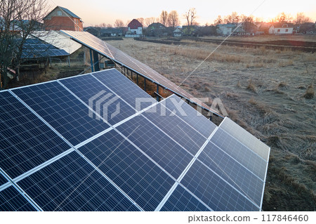 Solar photovoltaic panels mounted on stand-alone frame on backyard ground for generating of clean ecological electric energy. Concept of autonomous house 117846460