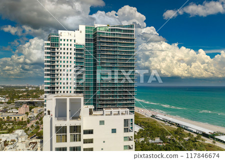 Miami Beach city in southern Florida, USA. High luxury hotels and condominium buildings. High angle view of tourist infrastructure in United States Miami Beach city in southern Florida, USA. High luxury hotels and condominium buildings. High angle view of tourist infrastructure in United States 117846674