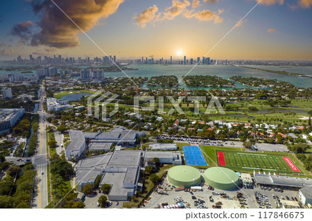 Miami Beach city in southern Florida, USA. High luxury hotels and condominium buildings. High angle view of tourist infrastructure in United States Miami Beach city in southern Florida, USA. High luxury hotels and condominium buildings. High angle view of tourist infrastructure in United States 117846675