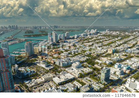 Miami Beach city with high luxury hotels and condos. High angle view of tourist infrastructure in southern Florida, USA Miami Beach city with high luxury hotels and condos. High angle view of tourist infrastructure in southern Florida, USA 117846676