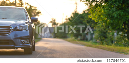 Panoramic view of new shiny expensive car parked on city street side in evening. Panoramic view of new shiny expensive car parked on city street side in evening. 117846701