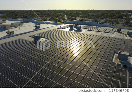 Photovoltaic solar panels mounted on industrial building roof for producing green ecological electricity. Production of sustainable energy concept 117846708