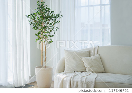 Stylish loft bedroom interior. Spacious design apartment with light walls large windows white couch sofa. Clean modern decoration with elegant furniture in minimalist Scandinavian style 117846761