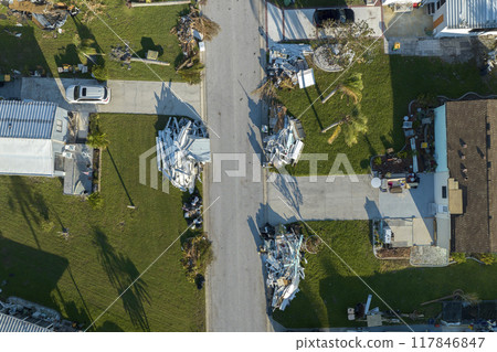 Destroyed by hurricane strong winds suburban houses in Florida mobile home residential area. Consequences of natural disaster 117846847