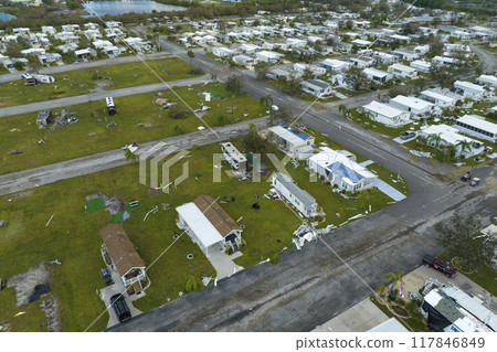 Destroyed RV camper vans and and mobile homes after hurricane in Florida residential area. Consequences of natural disaster 117846849