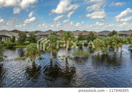 Flooded residential area with underwater houses from hurricane rainfall water in Florida suburban community. Aftermath of natural disaster in southern USA Flooded residential area with underwater houses from hurricane rainfall water in Florida suburban community. Aftermath of natural disaster in southern USA 117846895