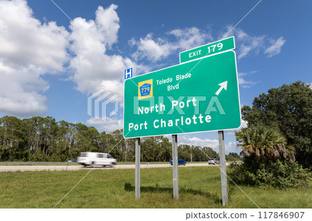 Freeway directional exit sign on interstate road in Florida, USA. I-75 highway junction leading to North Port and Port Charlotte 117846907
