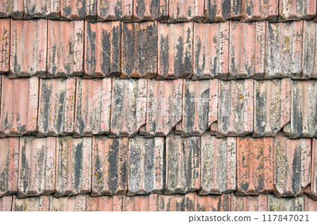 Closeup surface of old weathered ceramic tiles covering building roof Closeup surface of old weathered ceramic tiles covering building roof 117847021
