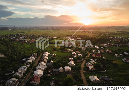 Aerial view of residential houses in suburban rural area at sunset Aerial view of residential houses in suburban rural area at sunset 117847092