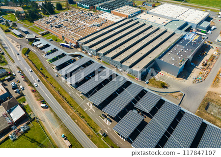 Aerial view of solar panels installed over parking lot with parked cars for effective generation of clean energy Aerial view of solar panels installed over parking lot with parked cars for effective generation of clean energy 117847107