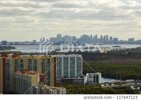 Aerial view of Sunny Isles Beach city with luxurious highrise hotels and condos on Atlantic ocean shore. American tourism infrastructure in southern Florida 117847123