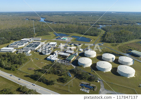 Aerial view of water treatment factory at city wastewater cleaning facility. Purification process of removing undesirable chemicals, suspended solids and gases from contaminated liquid Aerial view of water treatment factory at city wastewater cleaning facility. Purification process of removing undesirable chemicals, suspended solids and gases from contaminated liquid 117847137