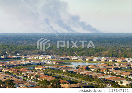 Air pollution with toxic smoke from prescribed forest fire close to rural neighborhood in Florida, USA 117847151
