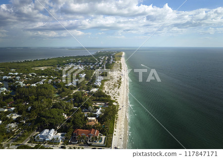 American waterfront houses in rural US suburbs. View from above of large residential homes in island small town Boca Grande on Gasparilla Island in southwest Florida American waterfront houses in rural US suburbs. View from above of large residential homes in island small town Boca Grande on Gasparilla Island in southwest Florida 117847171