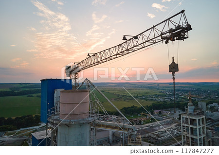 Aerial view of cement factory under construction with high concrete plant structure and tower cranes at industrial production area. Manufacture and global industry concept Aerial view of cement factory under construction with high concrete plant structure and tower cranes at industrial production area. Manufacture and global industry concept 117847277
