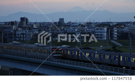 A Tokyu train crossing the Tamagawa Bridge with Mount Fuji visible in the background, seen from the observation deck at Tamagawa Sengen Shrine (Ota Ward, Tokyo) 117847558