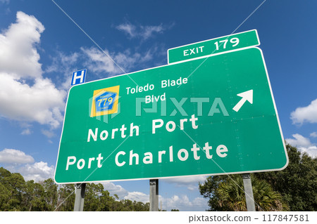 Highway interchange exit sign with direction to North Port and Port Charlotte in Florida. Interstate freeway travel in USA 117847581