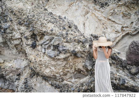 Coastal rocks and young woman 117847922