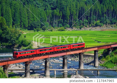 The Yufu Express crosses the 5th Kusu River Bridge in the setting sun. The Yufu Express crosses the 5th Kusu River Bridge in the setting sun. 117847965