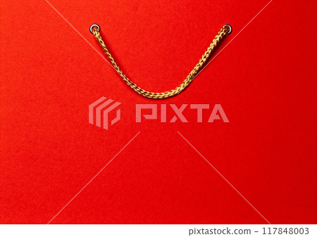 Red shopping bag with gold handles, symbolizing of shopping and retail. 117848003
